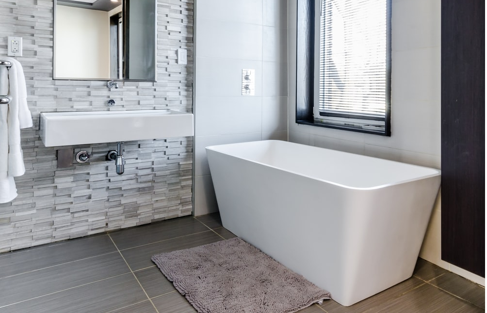 A bathroom with a rug.