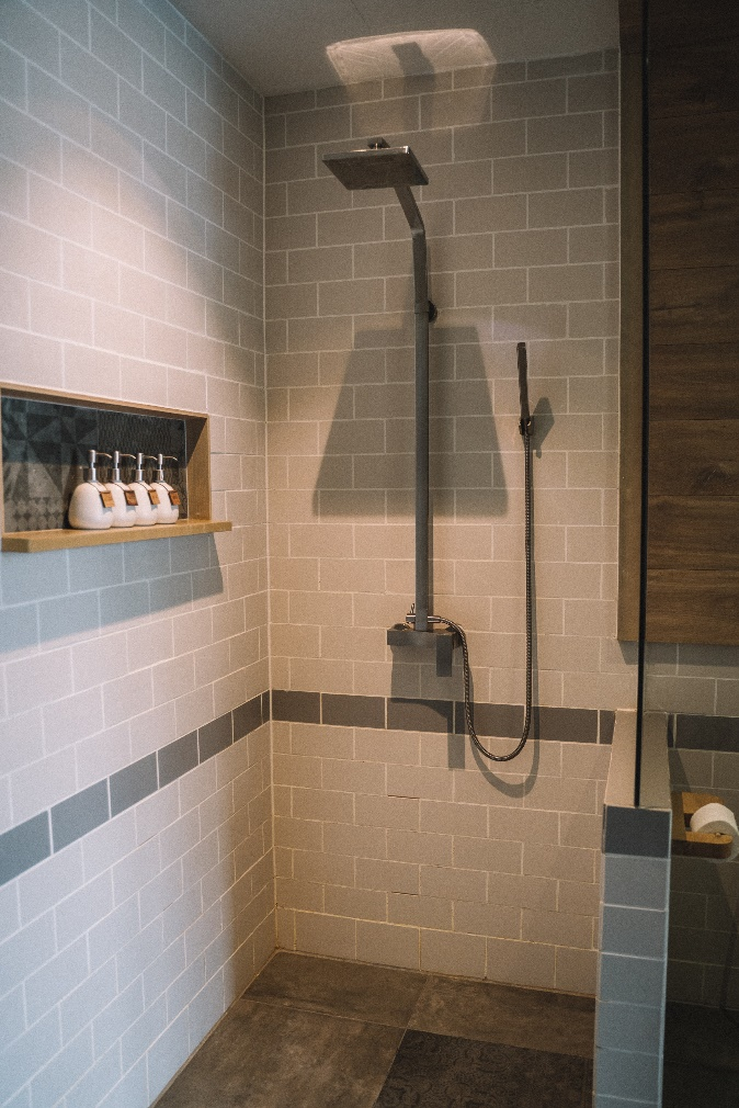 A newly-installed shower head in a bathroom